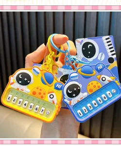 Detailed view of colorful astronaut toy piano keychains in bright yellow and blue colors