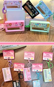 Portable mini electronic piano keychain toy with cute cartoon designs and functional music keys.