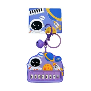 Astronaut themed mini toy piano keychain with 7 numeric buttons and purple bell
