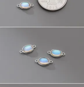 Close-up of S925 silver oval moonstone pendants with double loops for DIY jewelry