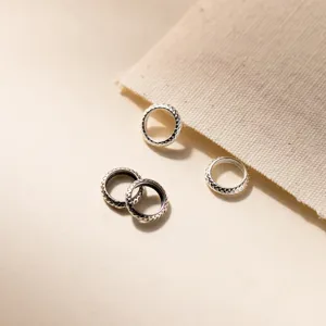 Detailed close-up of S925 vintage sterling silver wheel spacer beads with braided texture