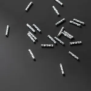 Detailed macro view of diamond-cut 925 sterling silver starry sky spacer tube beads