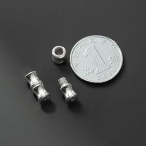 Close-up of S925 sterling silver screw clasps for DIY jewelry making with coin for scale