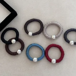 Assorted colors of silk-like elastic hair scrunchies featuring decorative silver pearls
