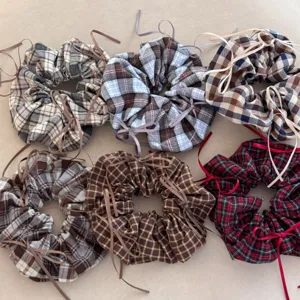 Assortment of vintage plaid hair scrunchies with ribbon bows for elegant styling