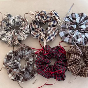 Variety of vintage plaid scrunchies with ribbon bows for elegant and retro hair styling