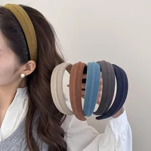 Detail of various colored textured sponge headbands for a high cranial top effect