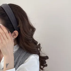 Close-up of grey textured sponge headband on model showing hair volume effect