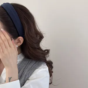 Close-up of a dark blue textured sponge headband for women, high-top hair accessory.