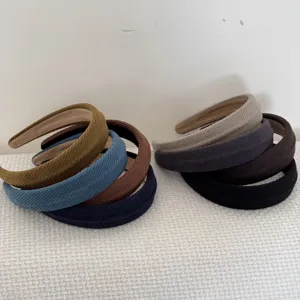 Macro view of textured corduroy padded headbands in various stylish autumn colors