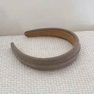 Close-up detail of a coffee brown textured sponge headband with a soft knit finish