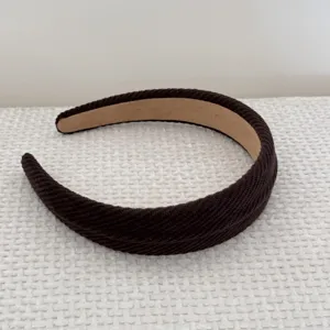 Close-up detail of textured brown sponge headband for high cranial top effect