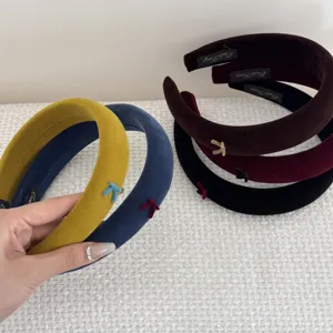 Macro view of high-quality velvet padded headbands with delicate bow detail.