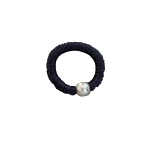 Elegant black silk scrunchie with a silver pearl charm on a clean white background