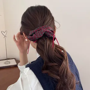Vintage plaid oversized scrunchie with red ribbon accents for preppy hairstyles