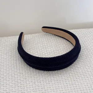 Detail view of navy blue corduroy padded sponge headband for high top hair style