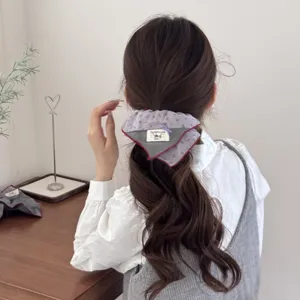Detailed view of a vintage forest style padded scrunchie worn in a low ponytail setup