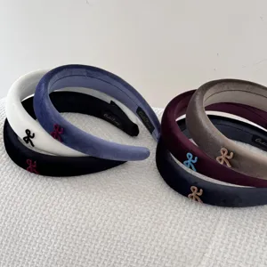 Close-up of assorted high-end velvet wide headbands with decorative mini bows