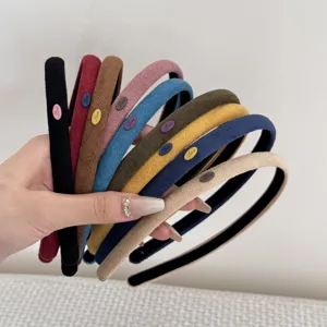 Close-up of colorful suede hairbands in various solid colors showing soft texture