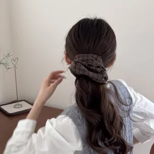 Retro dark brown plaid scrunchie styled in a low ponytail for a Korean aesthetic
