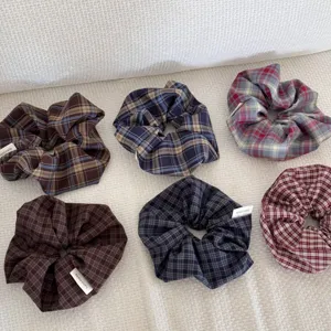Detailed view of six vintage checkered hair scrunchies in various dark color patterns