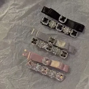 Detailed view of satin hair clips with sparkling square rhinestones in assorted colors