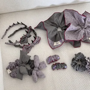 Detailed view of vintage padded scrunchies and bow headbands set in grey and purple