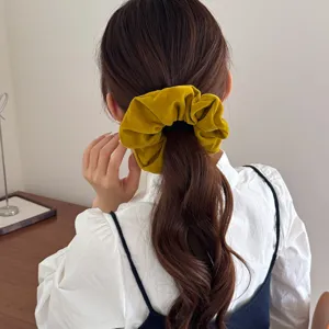 Retro mustard yellow velvet oversized scrunchie for elegant low ponytail hair styling accessory