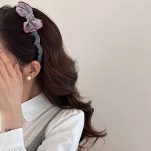 Retro forest style cotton-filled bow hair scrunchie shown on an elegant model side view