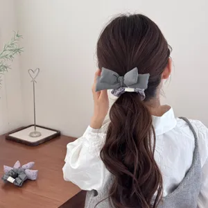 Vintage Mori-style grey cotton-filled bow scrunchie worn on long wavy hair