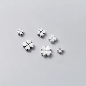 Close-up of polished S925 sterling silver four-leaf clover spacer beads for DIY jewelry making