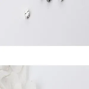 Close-up of S925 sterling silver four-leaf flower spacer beads for DIY jewelry making.
