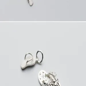 Close-up of S925 sterling silver flip-flop pendant showing intricate flower details and texture