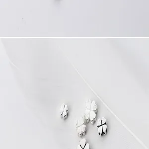 Close-up of S925 sterling silver four-leaf clover spacer beads for handmade DIY jewelry crafting