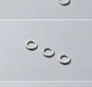 Close-up detail of three S925 sterling silver twisted jump rings for DIY jewelry