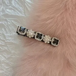 Close-up of a Korean style rhinestone duckbill hair clip featuring black square gemstones