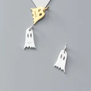 Detailed macro shot of silver and gold ghost pendants with S925 engraving