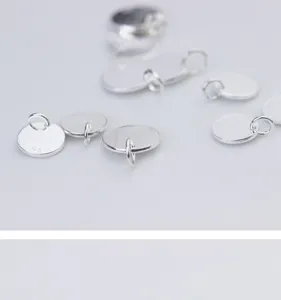 Close-up detail of polished S925 sterling silver round charms for DIY jewelry making