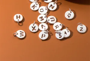 Macro view of S925 sterling silver hollow alphabet round charms for DIY jewelry crafting