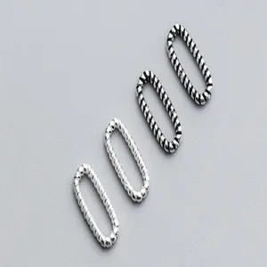 Close-up of four S925 sterling silver retro threaded oval closed jump rings for DIY.