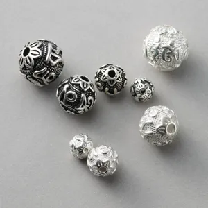 Close-up detail of S925 Thai silver spacer beads with mantra engraving for DIY