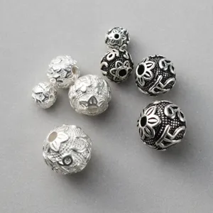 Detailed view of S925 Thai silver spacer beads featuring vintage floral mantra patterns