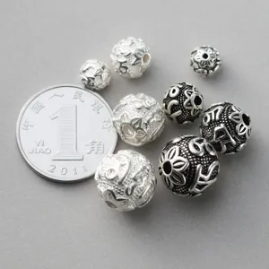 Detailed macro view of S925 sterling silver mantra spacer beads with retro Thai finish