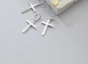 Macro detail of smooth S925 sterling silver cross pendants for DIY jewelry making