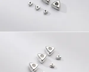 Close-up macro view of S925 sterling silver geometric triangle spacer beads for jewelry
