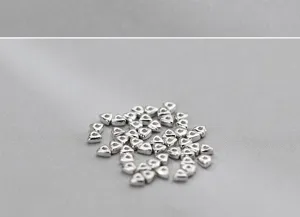 Close-up of S925 sterling silver triangular spacer beads for DIY jewelry making