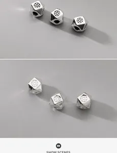 Detail of faceted S925 sterling silver square spacer beads with floral engravings