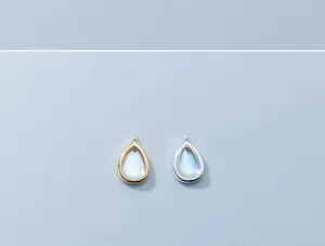 Close-up of gold and silver S925 silver waterdrop pendants with moonstone