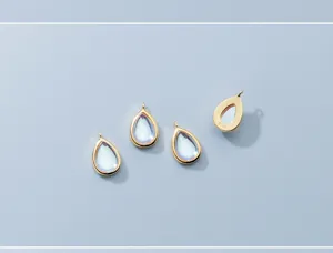Close-up showing S925 silver gold-plated synthetic moonstone teardrop jewelry pendants