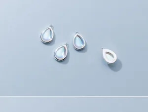 Macro detail of S925 sterling silver water-drop pendants with synthetic moonstones